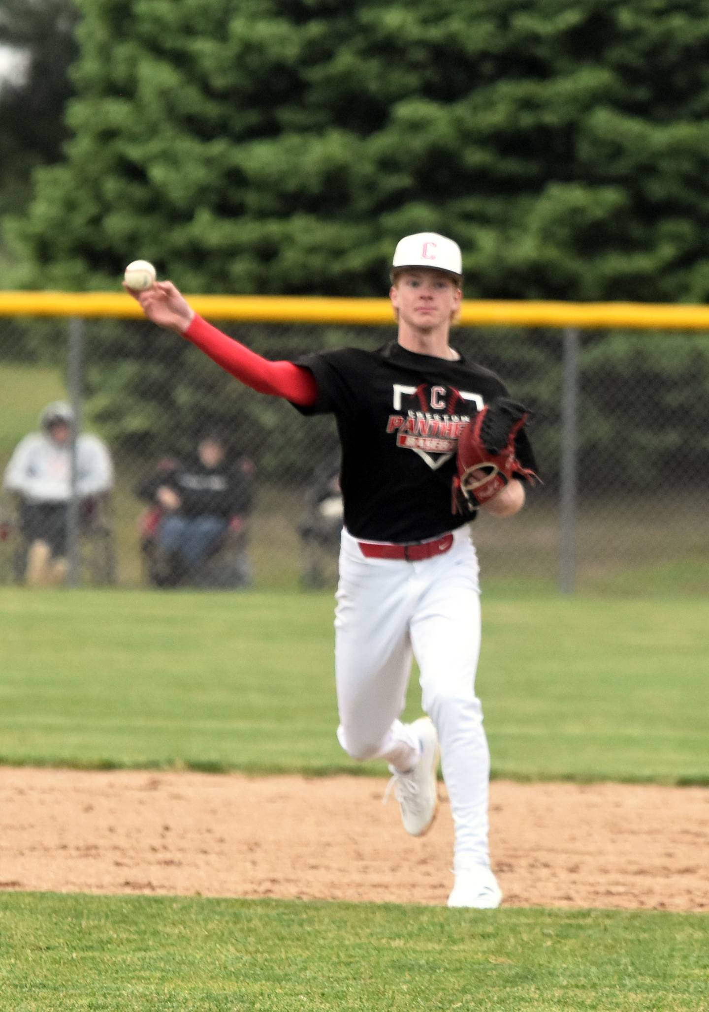 Creston shortstop Tanner Ray throws a ball to first after fielding a grounder.