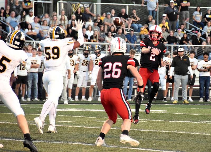 Tanner Ray completes a pass to running back Jackson Pettegrew Friday in a narrow 29-27 loss to Atlantic.