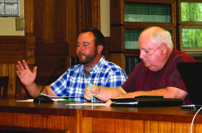 Adair County Supervisor John Twombly (right) listens to fellow Supervisor Matt Wedemeyer make a point during a meeting.