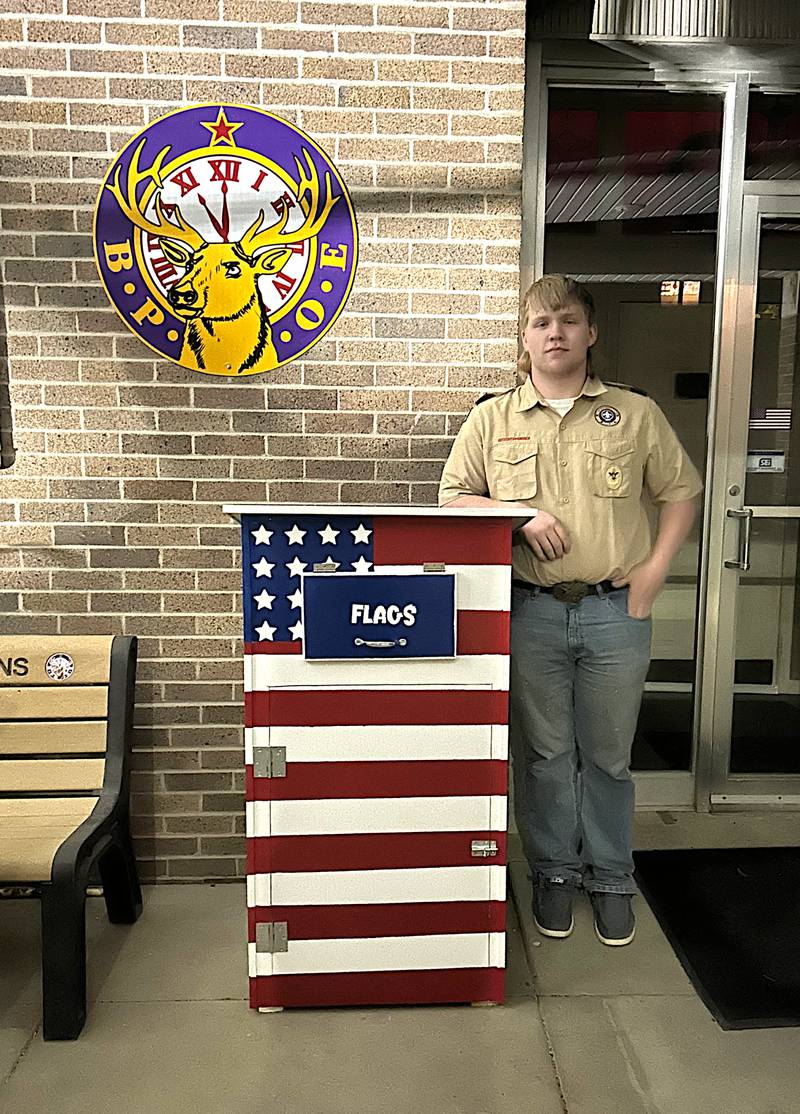 Boy Scout Gunner Martwick poses with his completed Eagle Scout Service Project. The project is a flag retirement container where those wishing to honor their worn-out flags can give them to their local scout troop.