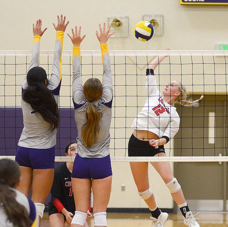 Creston senior Bailee Schmitt attacks a double block by Denison-Schleswig Thursday. Schmitt had two kills in the match and totaled nine kills Saturday in the Red Oak Tournament.
