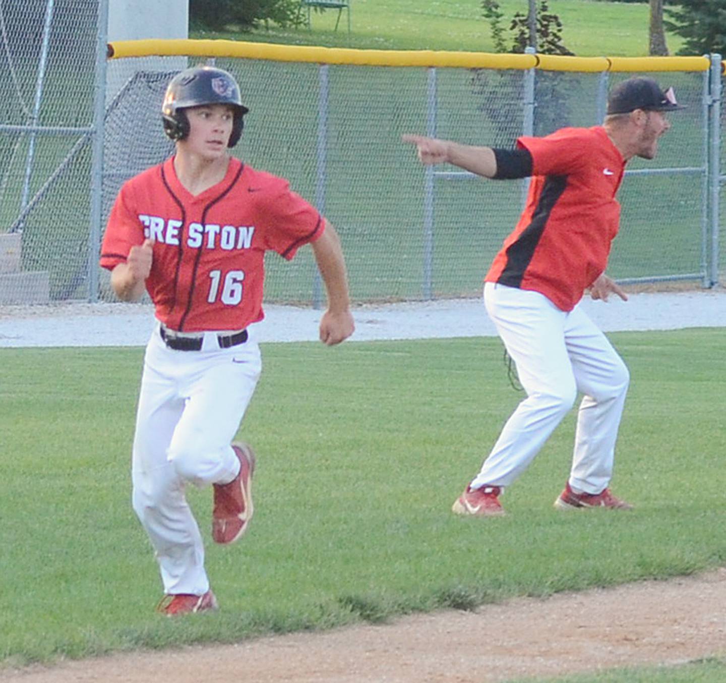 Tyler Riley runs home as coach Brandon Phipps directs another Panther baserunner after teammate Tom Mikkelsen's hit to the outfield was misplayed in Friday's substate game. Riley's run was part of a four-run rally to open up a 5-0 lead in the fourth inning.
