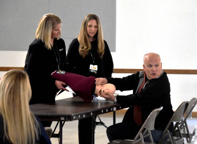 Dr. Dean Moews, left, demonstrates a technique used for babies being delivered with shoulder dystocia Friday during a training for Adair County Health emergency staff at the Adair County Fairgrounds. Moews is the new ER medical director.