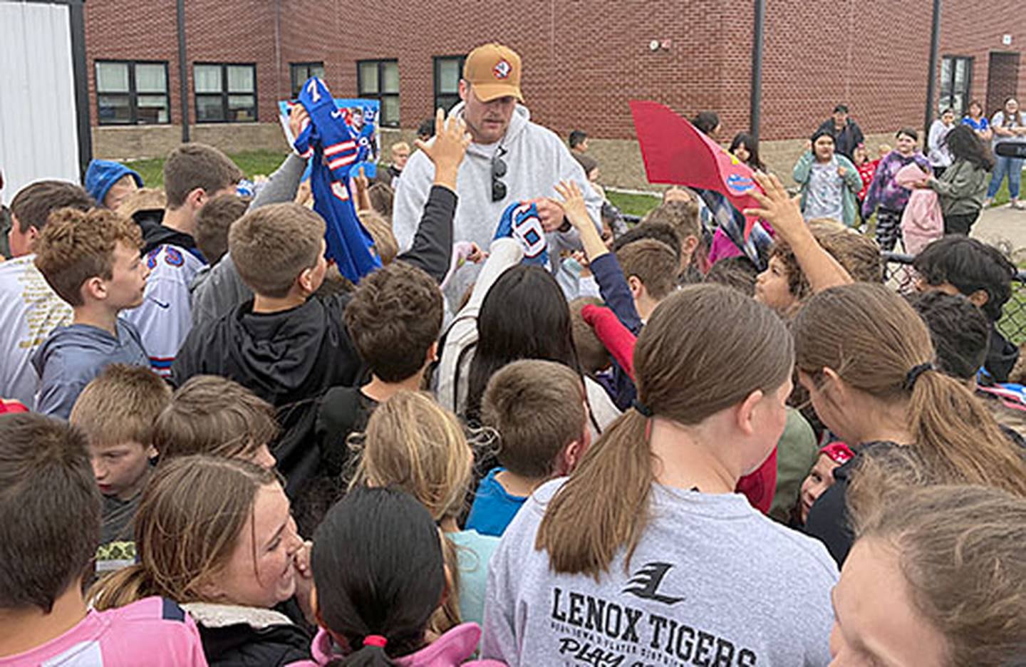 Buffalo Bills tackle Spencer Brown was mobbed by students seeking autographs when he visited recess on the school playground Friday.