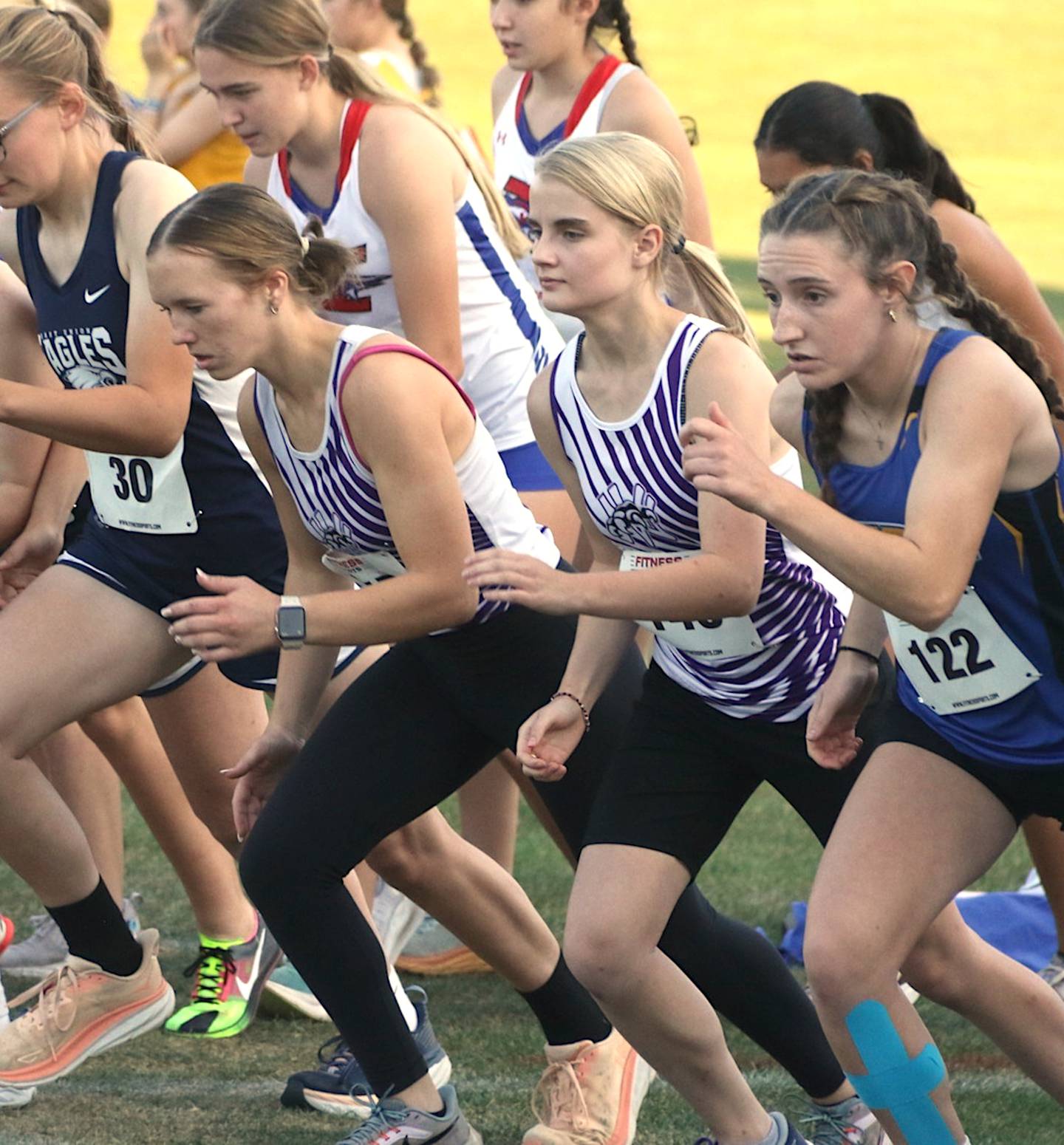 Nodaway Valley girls Jazz Christensen, left, and Kaylee Van Horn go toe to toe with competitors at the start of the Wolverines' home cross country meet at Greenfield Golf and Country Club Monday, Oct. 7.
