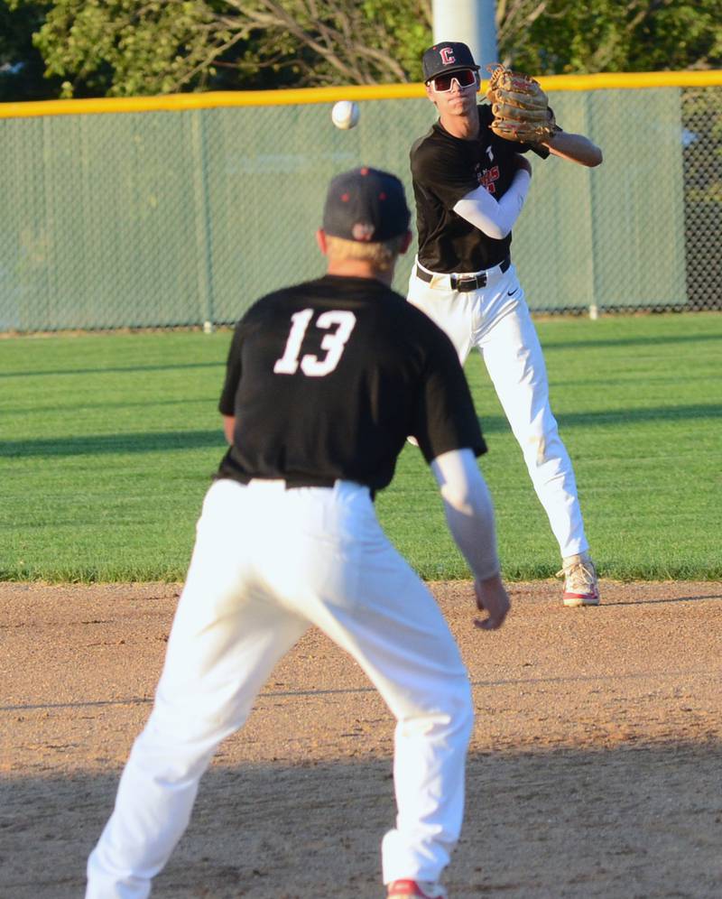 Creston second baseman Dylan Hoepker throws to first baseman Sam Henry after ranging to his left to field a ground ball against ADM Monday night. Hoepker scored a run and Henry hit an RBI double in the 3-2 victory.