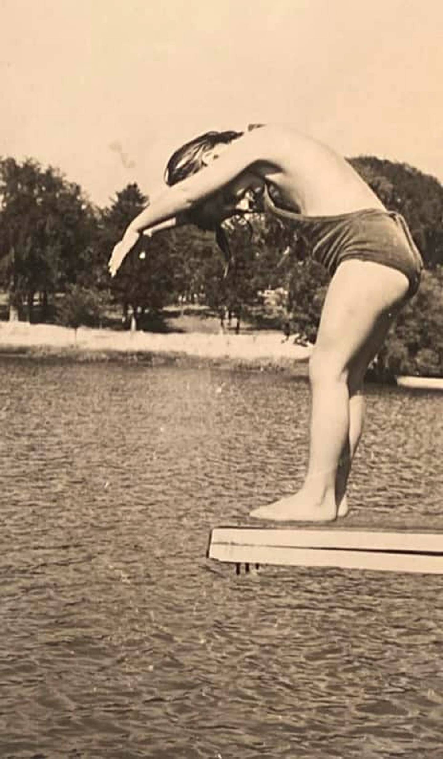 Five-year-old Alicia Ann Dooley prepares to dive into McKinley Lake in July 1937.