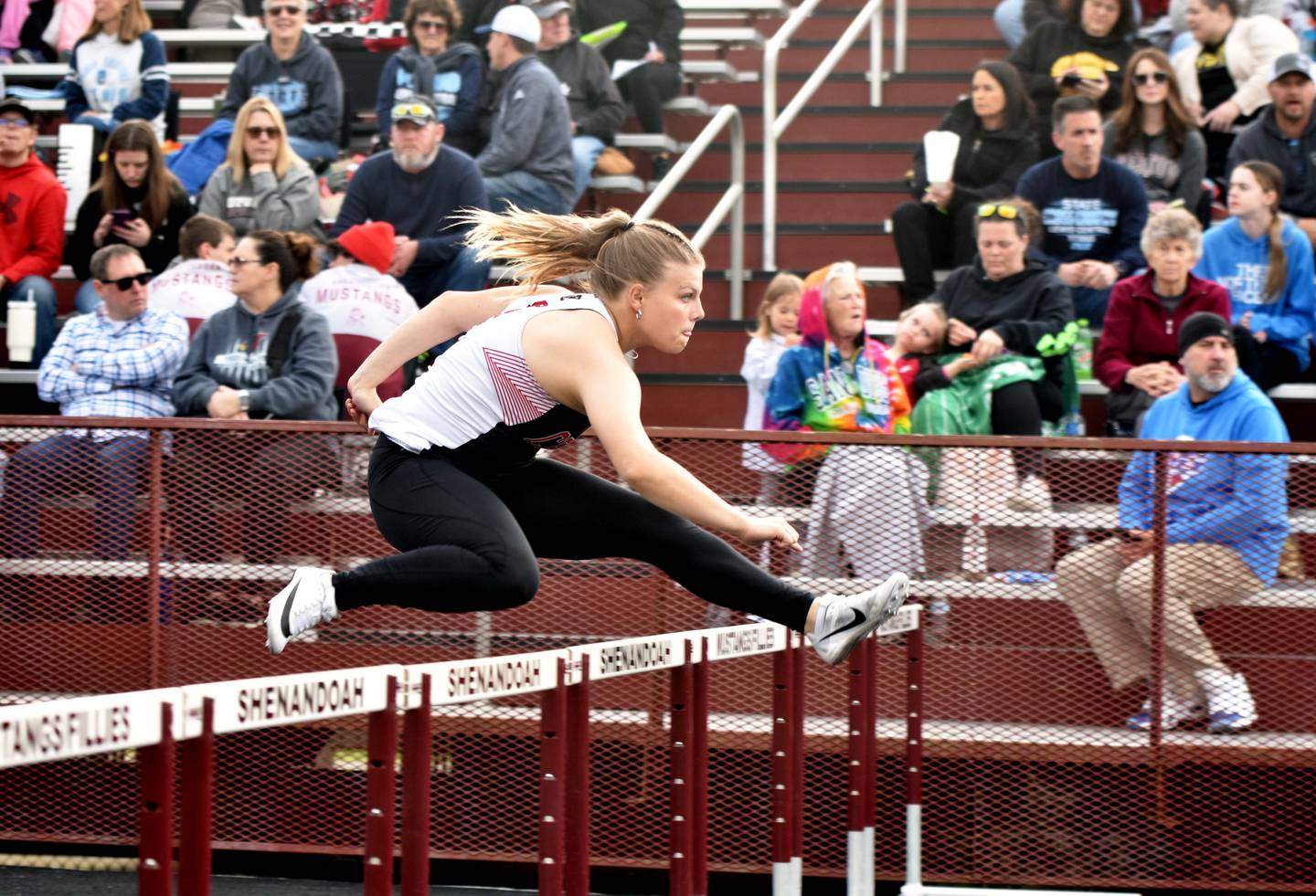 Creston’s Evy Marlin clears a hurdle during the shuttle hurdle relay Thursday at the Hawkeye 10 track and field meet in Shenandoah. The relay placed sixth while the girls took 10th overall.