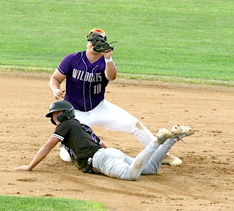 Wolverine senior Eli Harris slides into second base ahead of the throw to WCV's Zach Teague in a recent playoff game in Ogden.