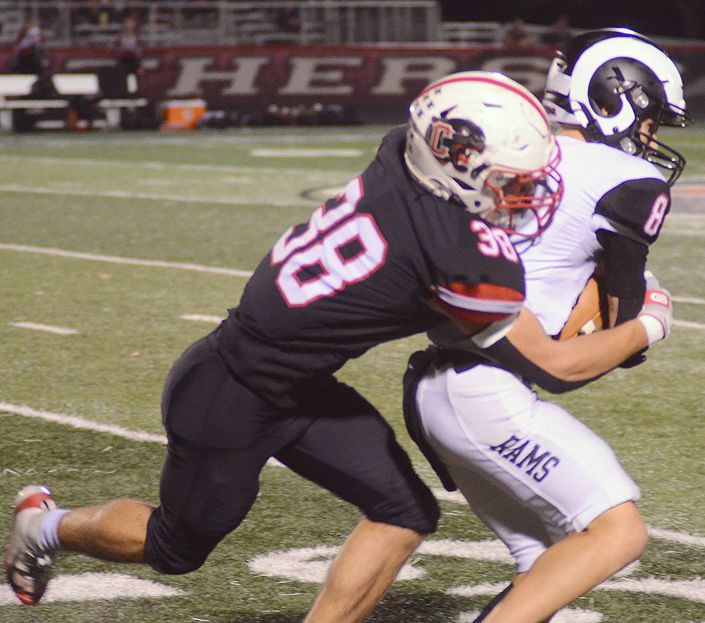 Creston safety Lane Travis (38) tackles Greene County receiver Jaron Jacobs after a pass reception. Travis had two solo tackles in the victory.