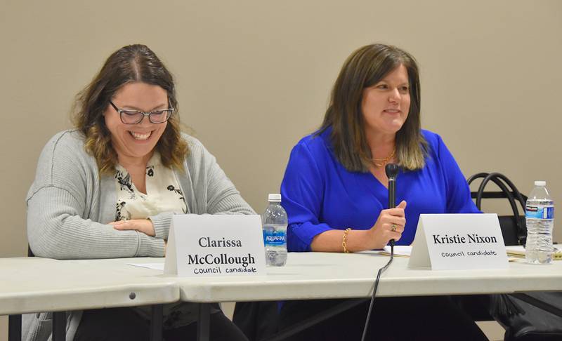 Clarissa McCollough, newcomer to Afton's city council race, smiles while incumbent Kristie Nixon speaks during Afton's candidate forum.