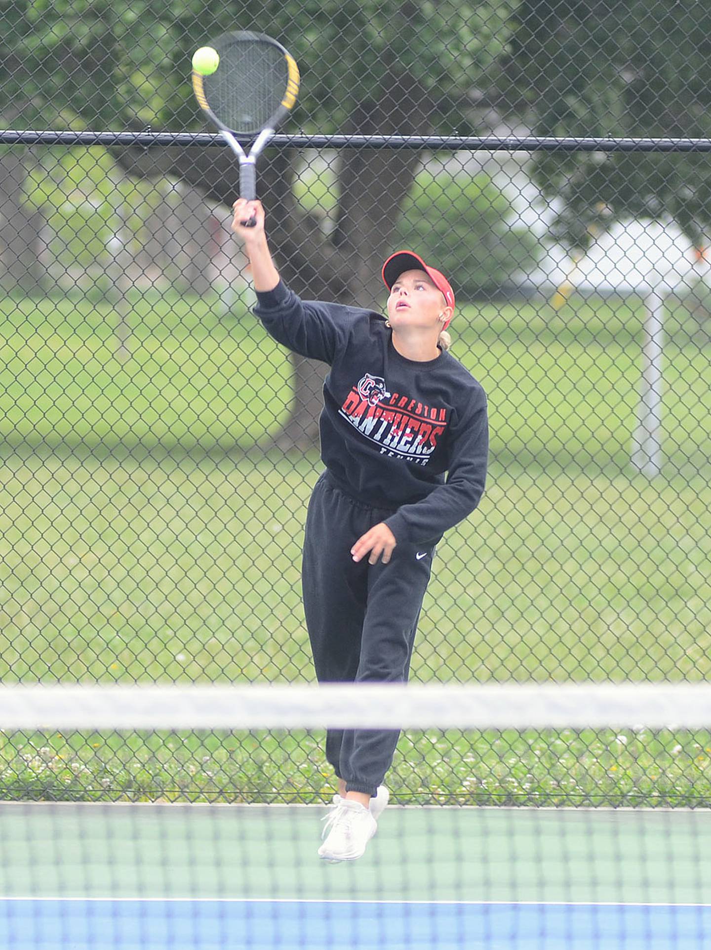 Creston's Ava Adamson serves to Clarinda's Riley Nothwehr during their No. 1 singles match in Tuesday's dual regional.