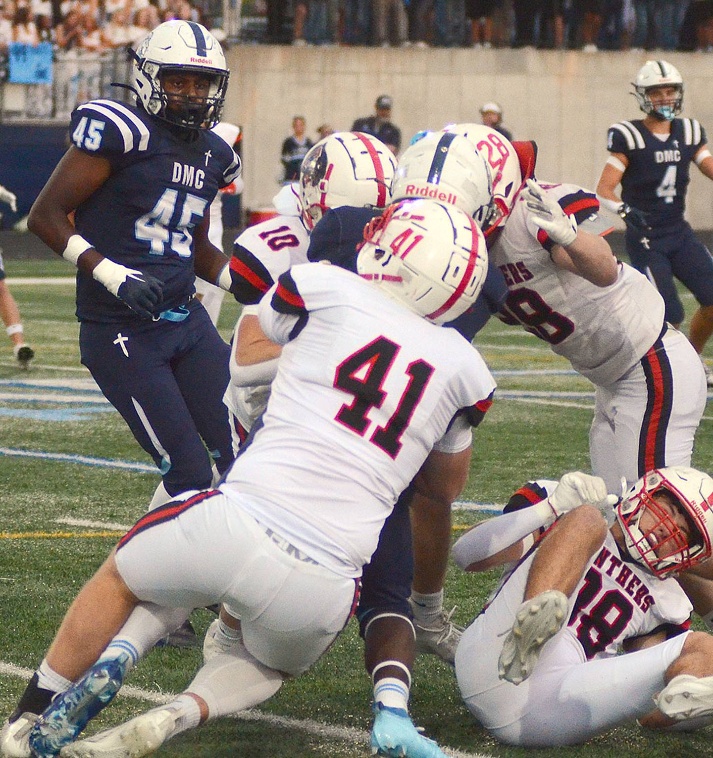 Tom Mikkelsen (41), Coltyr Frey (10) and Kal Barber (28) wrap up Des Moines Christian running back David Tokheim during Friday's game. Creston's rushing defense showed improvement Friday against the state-ranked Lions.