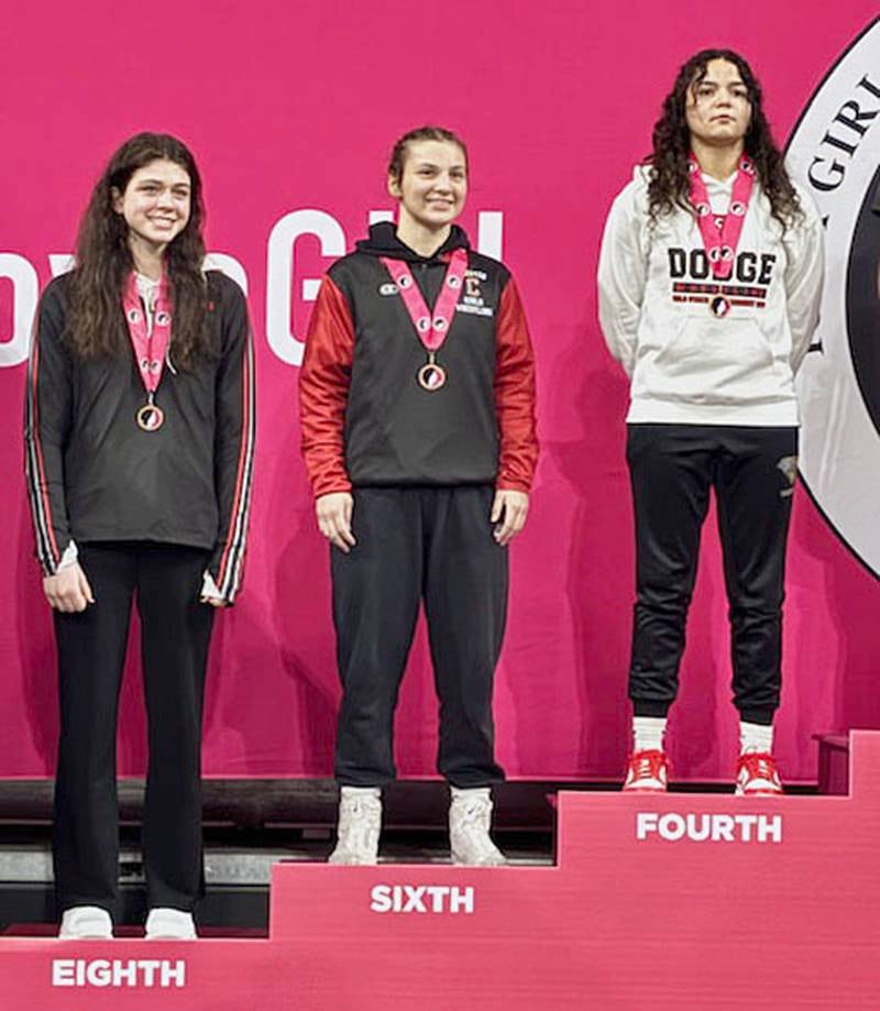 Grace Keeler of Creston (center) joins other Class 2A medal winners at 135 pounds during the awards presentation Friday at the Girls State Wrestling Tournament.
