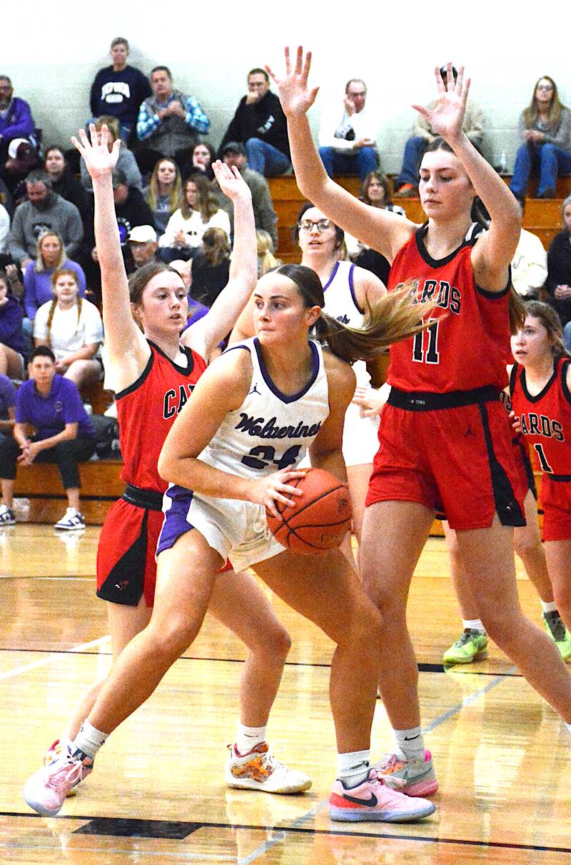NV senior Lindsey Davis faces a double team in the paint against Treynor, but still managed 27 points against the Cardinals as she and the Wolverines survived a top-10 matchup on opening night.