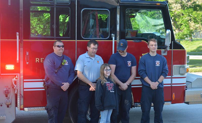 Firefighters from the Creston Fire Department stand behind Mary Keller, one of the winners of the Iowa Firefighters Association Poster Contest. From left to right, Assistant Fire Chief Daniel Stull, Fire Chief Todd Jackson, Firefighter Vincent Cox, Firefighter Brandon Hammons.