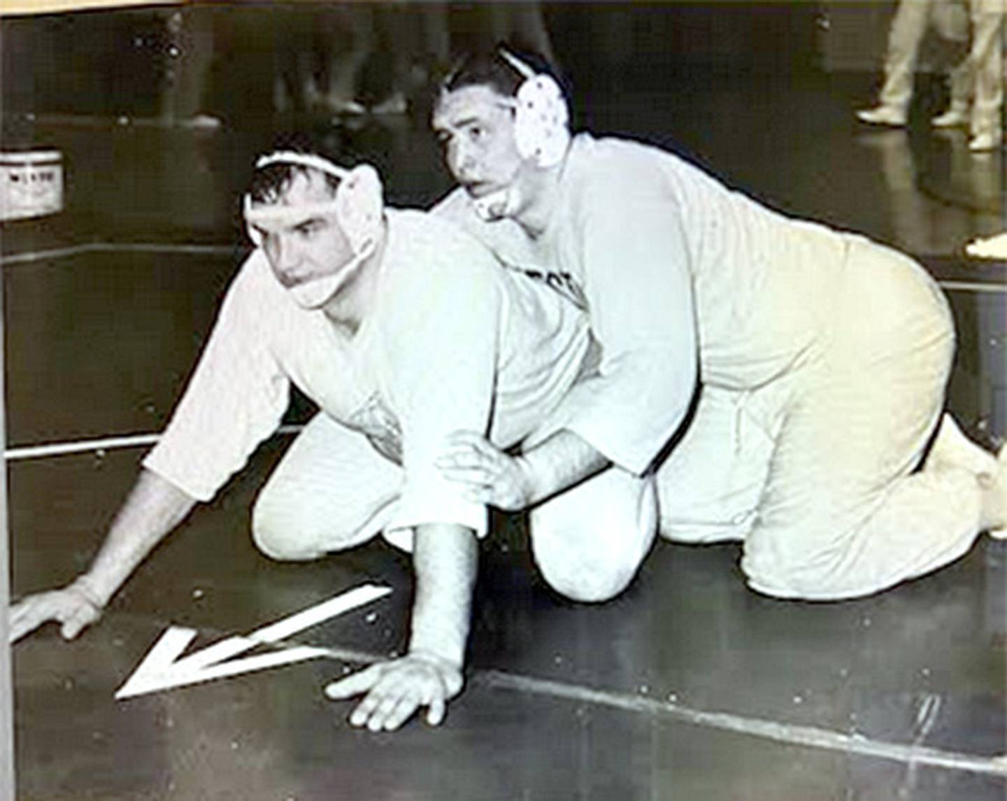 Creston's Doug Minnick (top) wrestles with coach Bill Lewis, Creston's first head wrestling coach in the early 1960s.