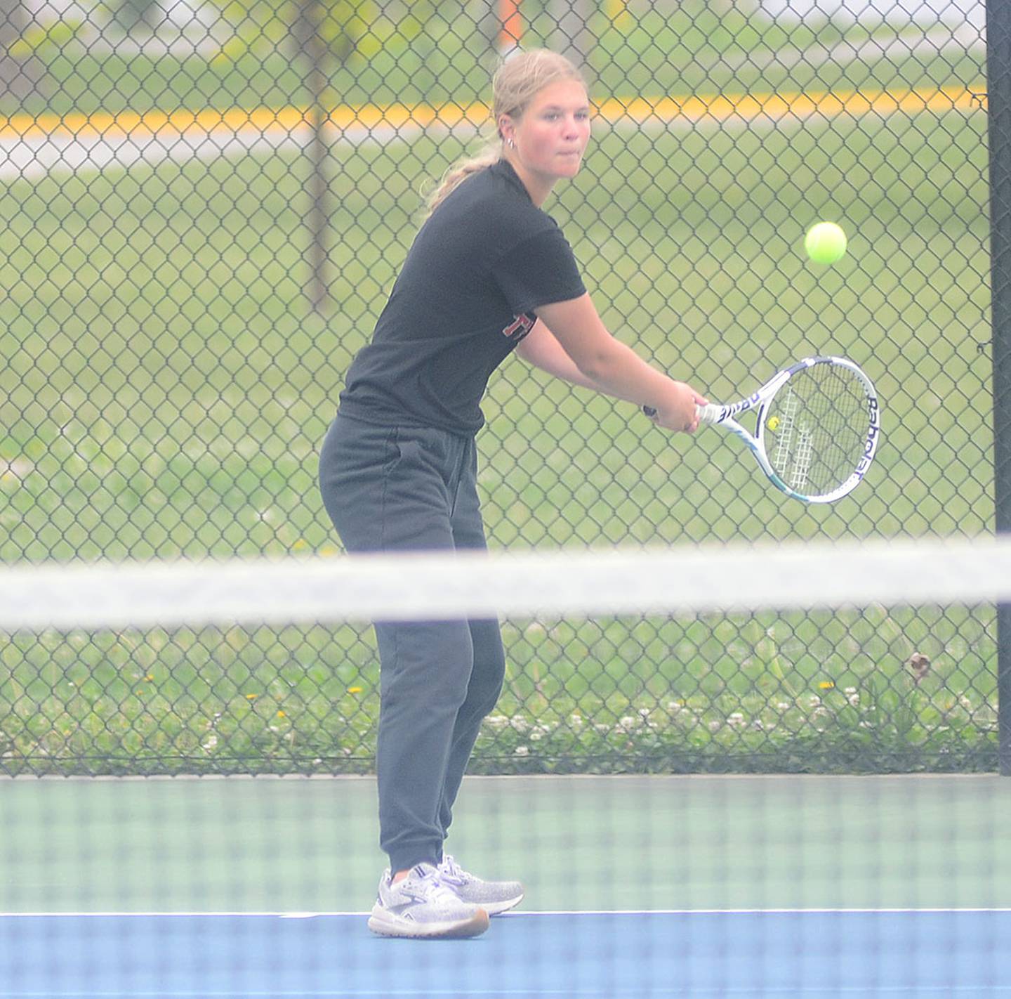 Creston freshman Marlee Stalker concentrates on a backhand return during her No. 6 singles match in Tuesday's dual regional.