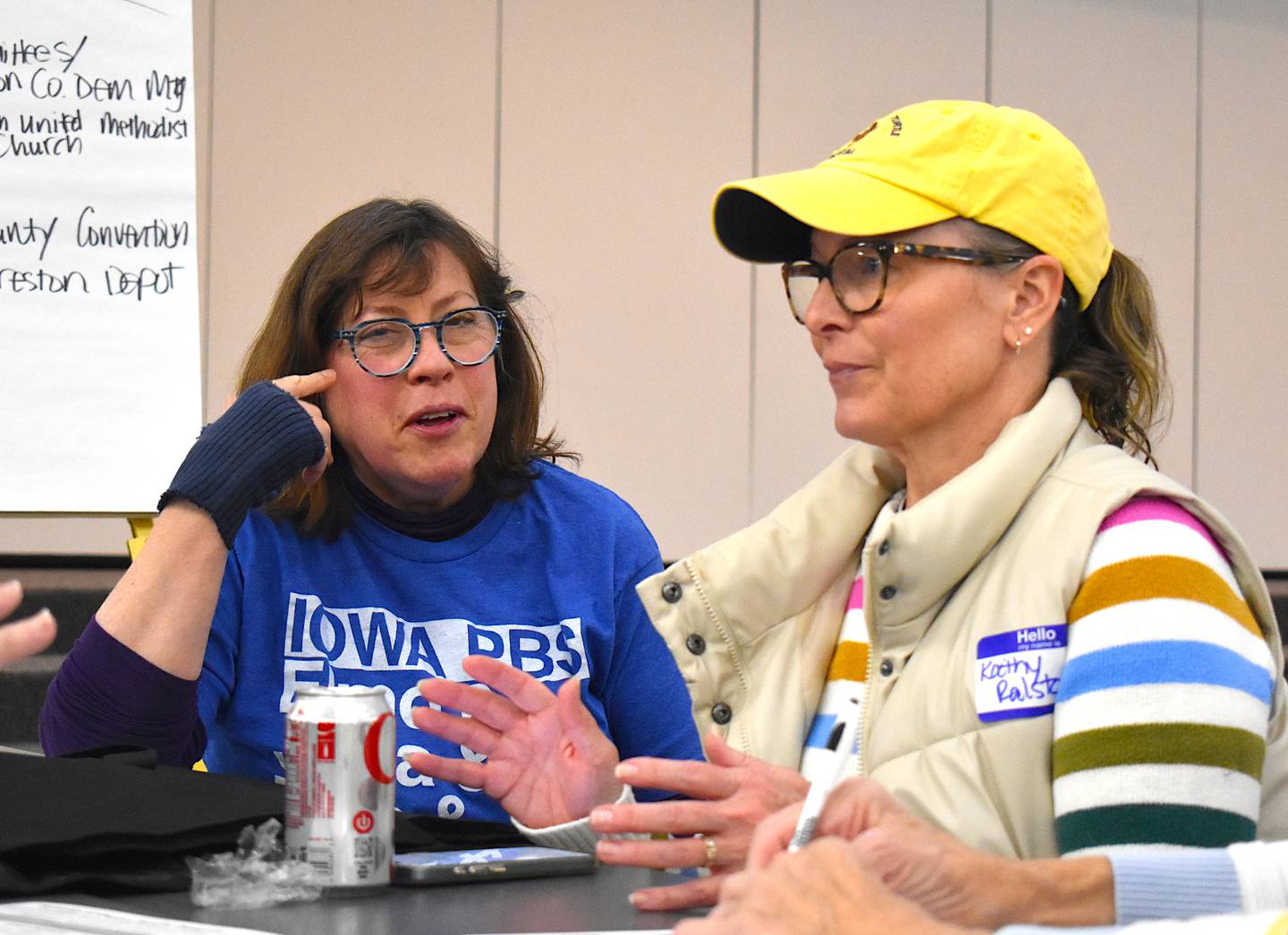 Julia Weishaar-Mullin and Kathy Thorne Ralston discuss with other Democrats during the 2026 caucus.