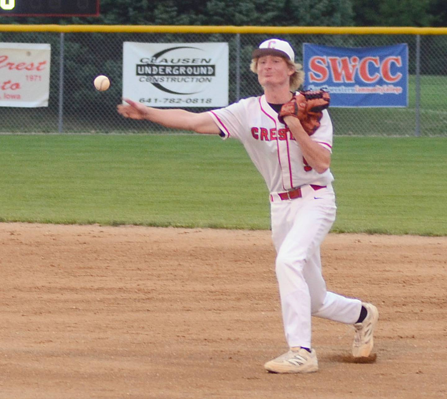 Creston second baseman Tommy Sand throws to first base after fielding a ground ball against Glenwood Thursday.