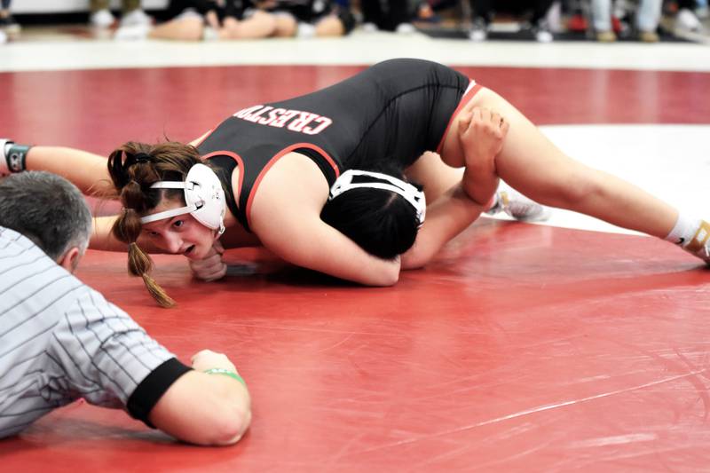 Creston junior Grace Keeler holds Andie Branson of Knoxville to the mat in the 140-pound semifinals. She went on to win in the finals.