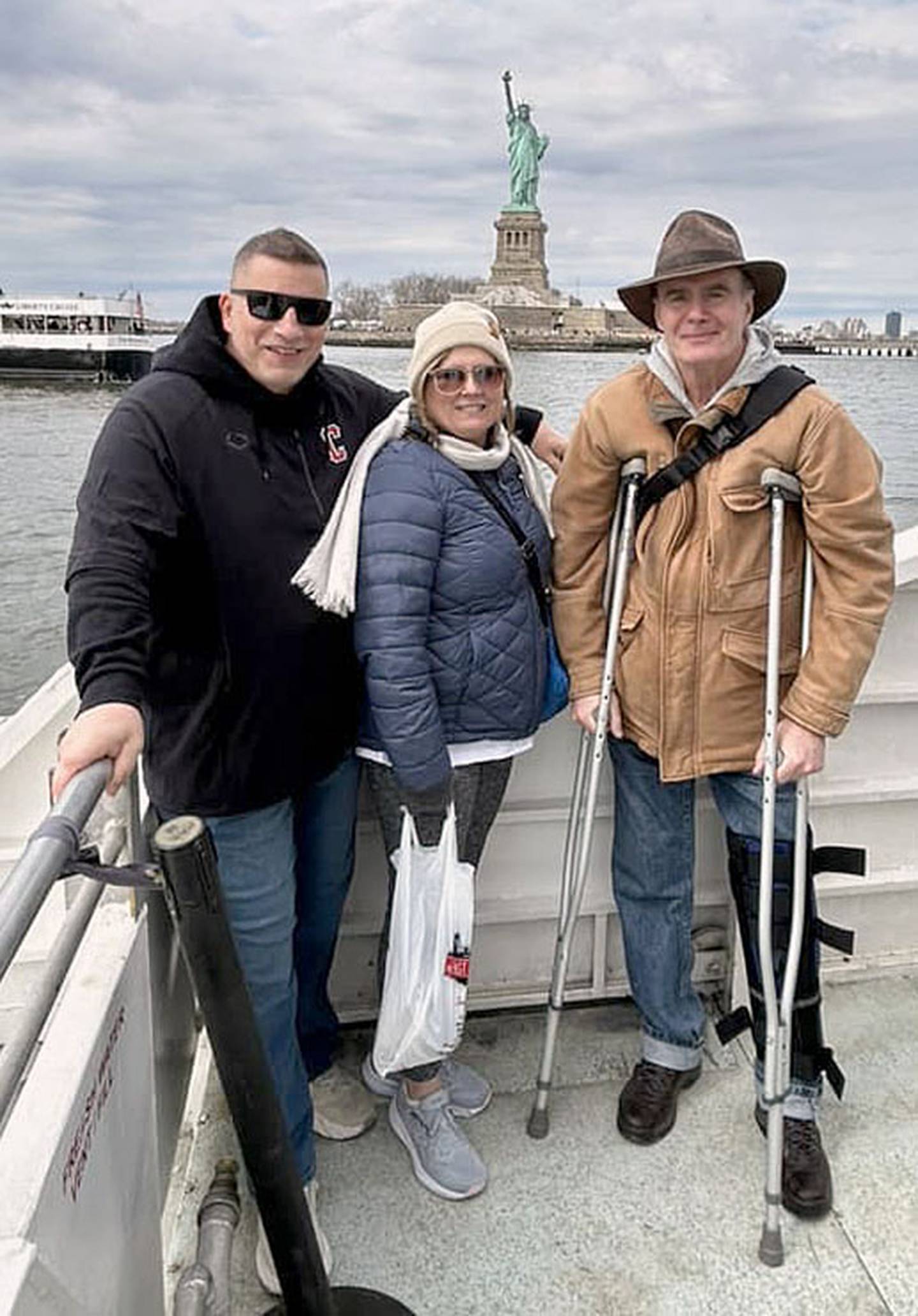 Paula and Todd Jacobson are shown with "Mike," their New York City tour guide for several trips, on their Ellis Island cruise. Mike broke his leg playing hockey two days earlier, but still directed the tour for Creston students.