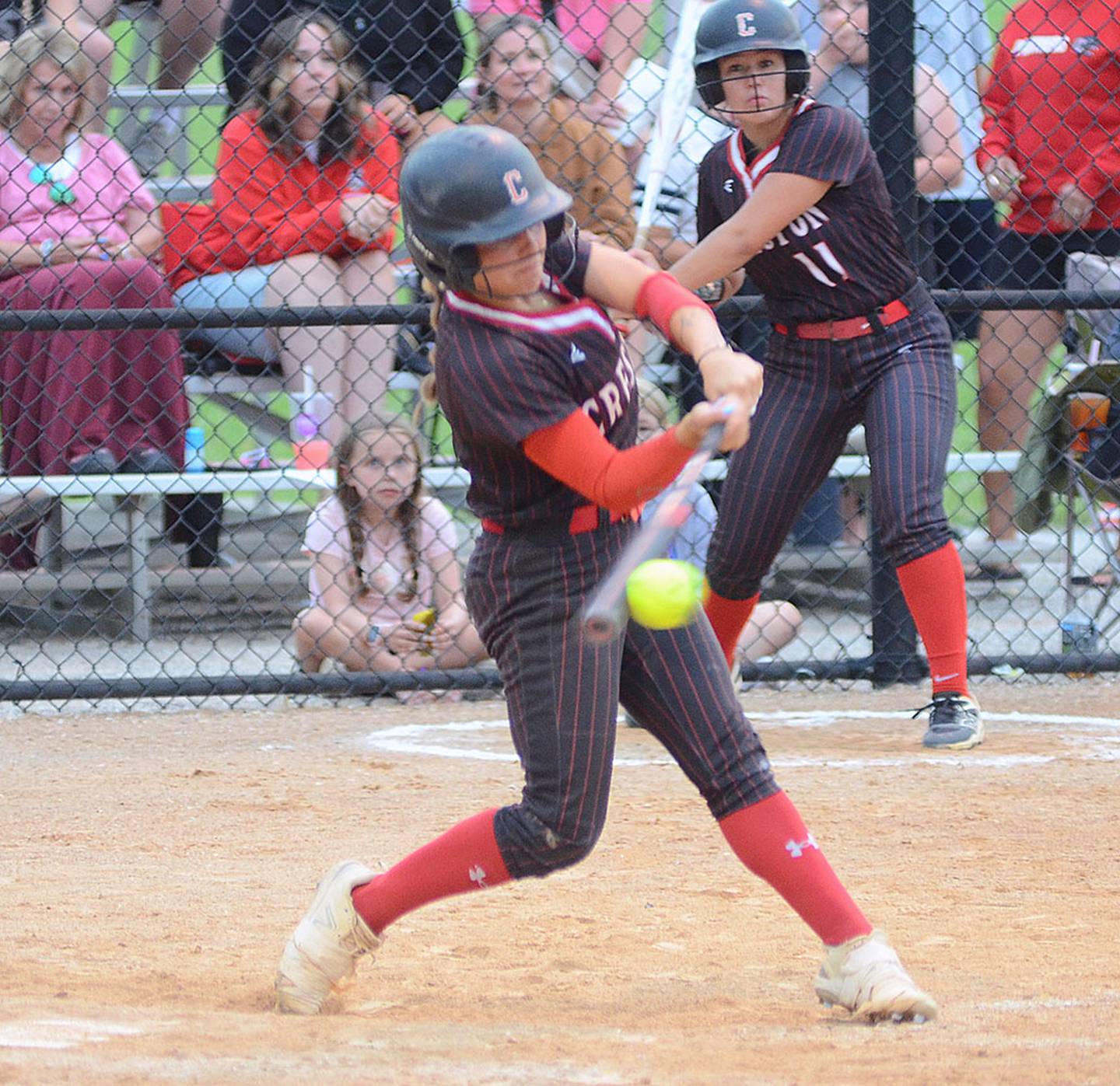 Creston's Evy Marlin hits the ground ball to shortstop that scored Jersey Foote from third with the winning run in Creston's 3-2 victory over Lewis Central.