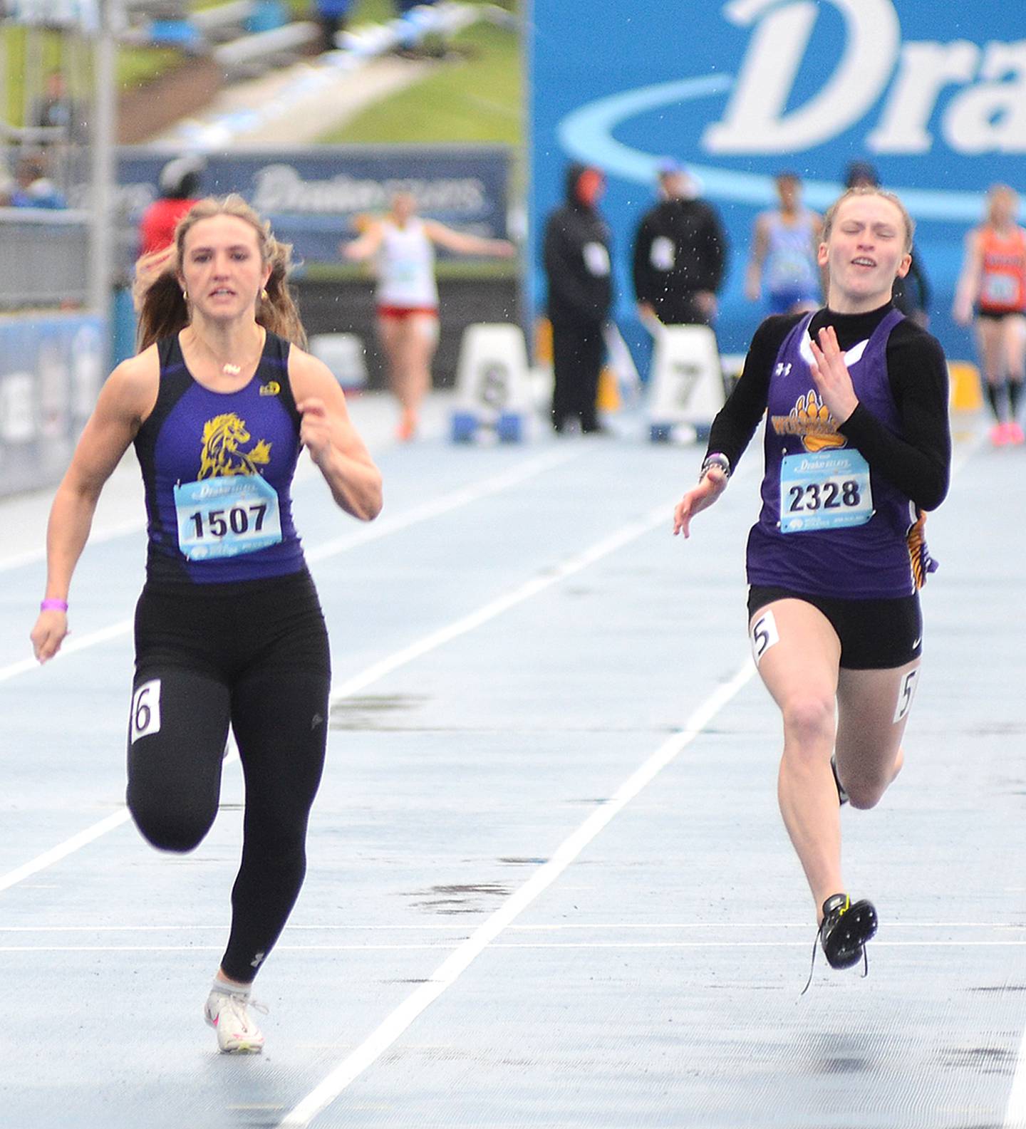 Aleksys Gannon of Murray (left) runs in the Drake Relays girls 100 meter dash Friday morning. Gannon placed 12th in 12.82, Murray's all-time best placing at the Drake Relays.