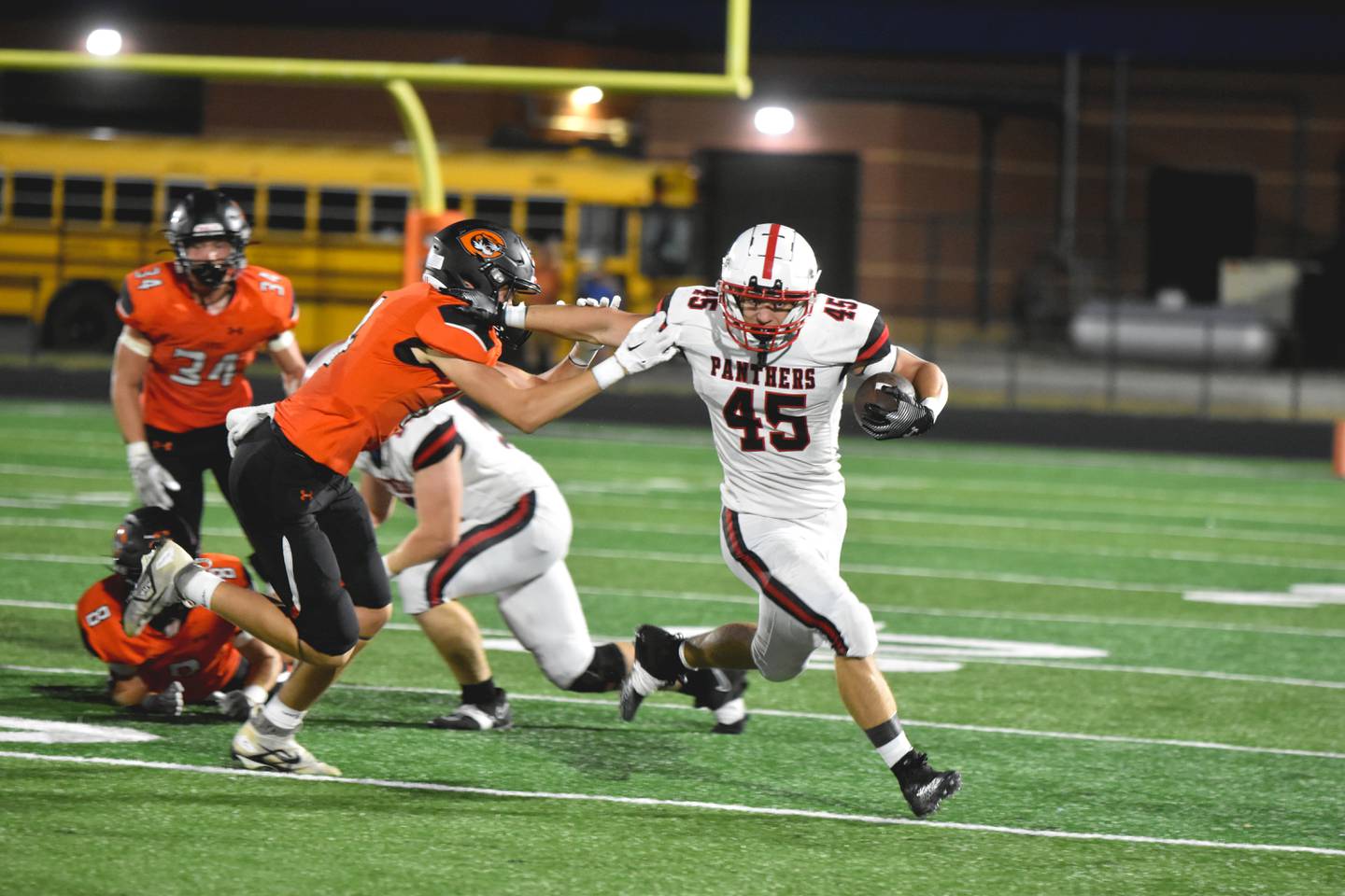 Panthers star running back Brennan Hayes stiff-arms a Carroll defender Friday as the Panthers took a 50-21 victory over the Tigers. Hayes only logged 26 rushing yards, but led the team in receiving yards with three receptions for 213 yards and two touchdowns.