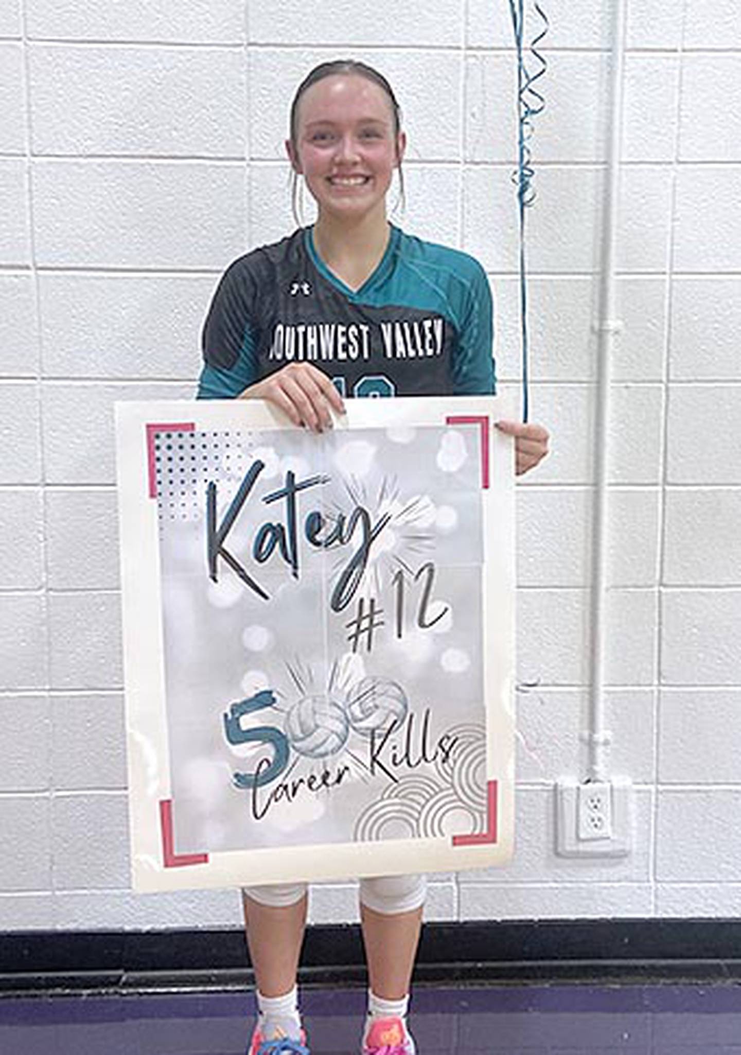 Katey Lillie was presented a poster signifying her 500th career kill for the Southwest Valley Timberwolves after the team's 3-0 regional semifinal win at Stanton.