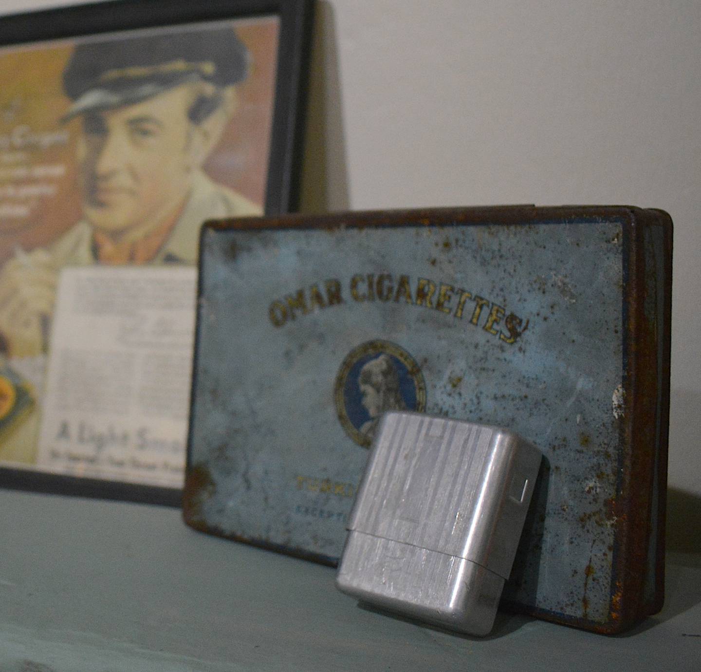Old cigar tins and advertisements are featured in a cigar room exhibit. Other features in this room include a chess and checkers table.