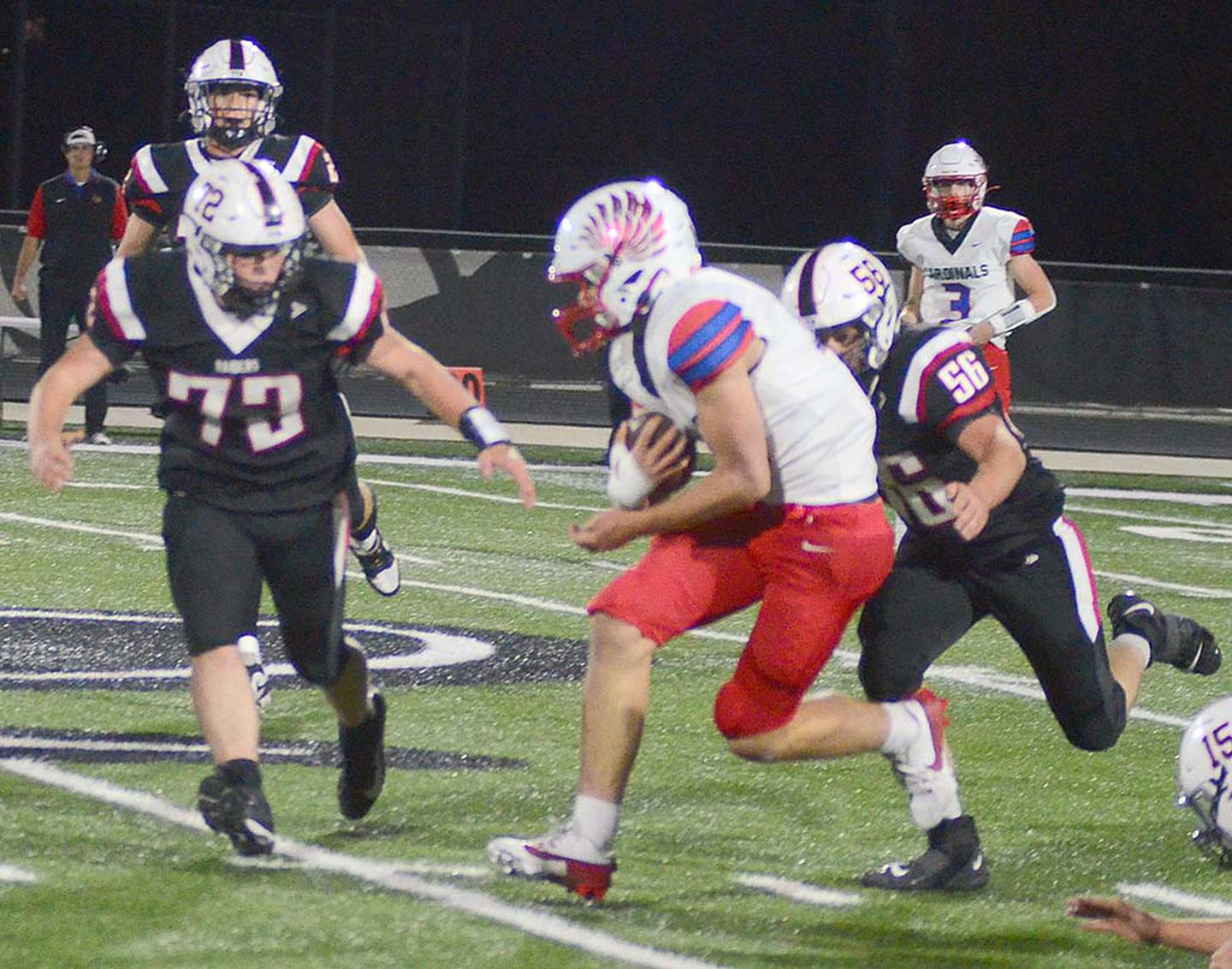 Mount Ayr defensive players Tucker Larson (56) and Bracken Collier (72) close in on Earlham receiver Josh Winey after a reception Friday night.