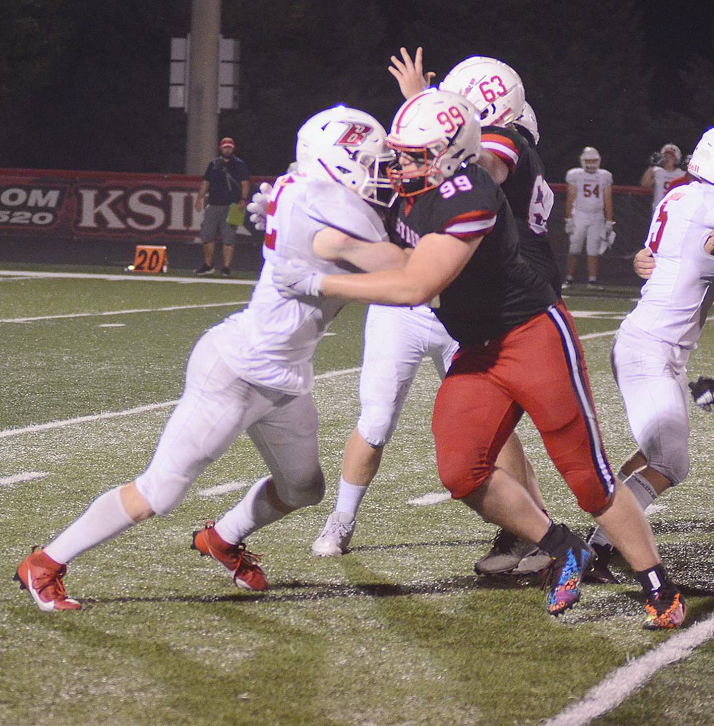 Creston defensive end Max Chapman (99) and nose tackle Tom Mikkelsen (63) stop Ballard running back Eli Rouse during Friday's 48-28 victory. Chapman had five tackles for losses.