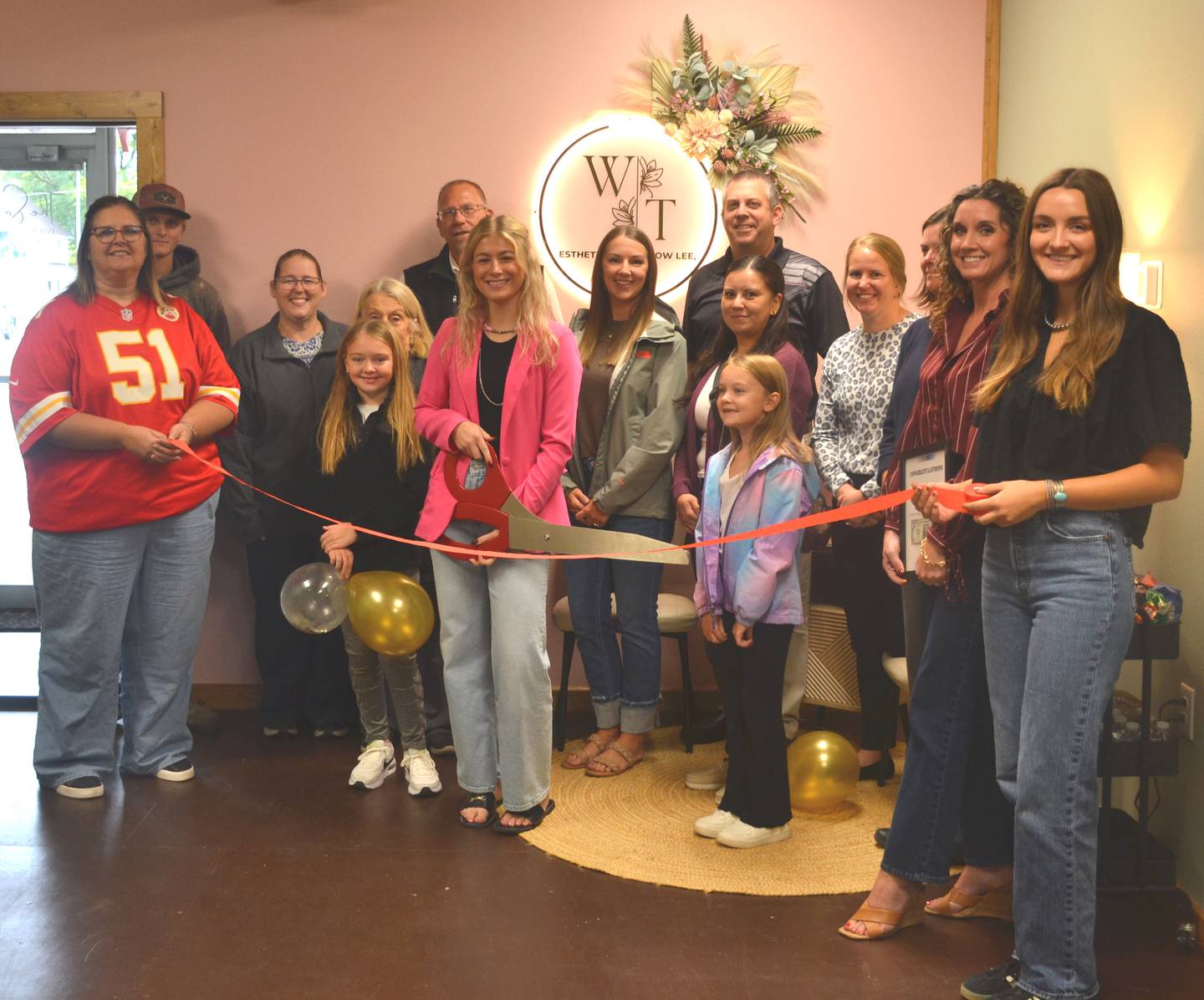 Willow Thompson prepares to cut the ribbon during the Creston Chamber of Commerce's grand opening for Esthetics by Willow Lee.