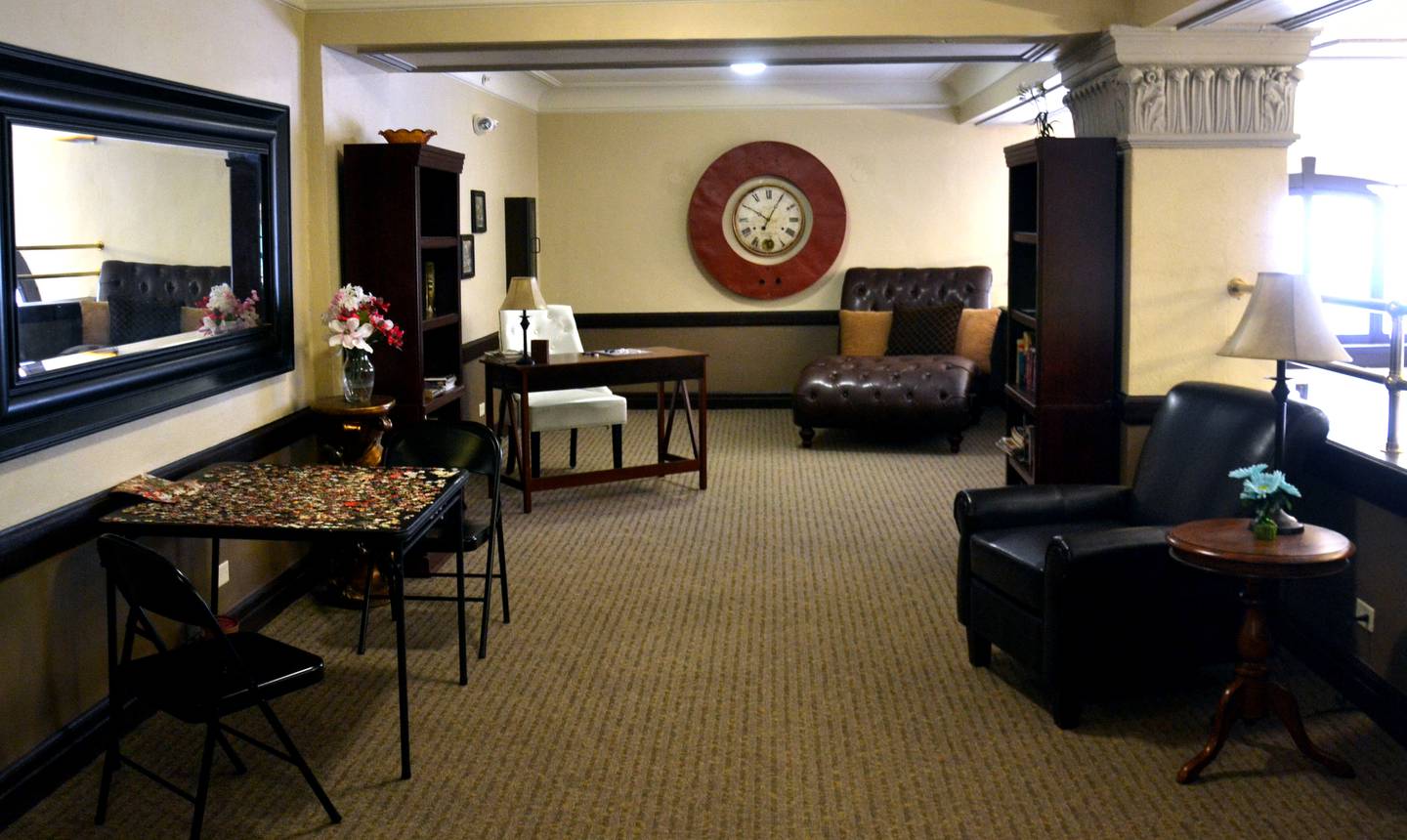 The apartment's library features a large metal "O" taken from the original Iowana sign.