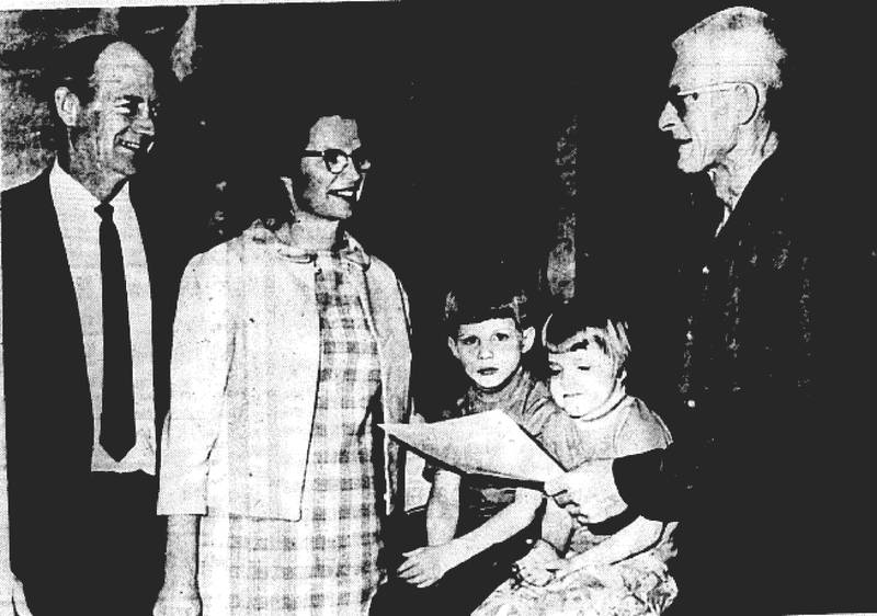 Mr. and Mrs. J. Eugene Miller and their family, of rural Creston, are presented a certificate by Rex Simpson, right, a member of the county F.H.A. Committee. With them are the two youngest of the 10 Miller children, Mat and Diane. The Miller family was named the Farmers Home Administration Family of the Year by the Creston F.H.A office.