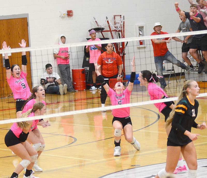 Creston volleyball players celebrate after a tip by Braylee Pokorny (right) scored the final point in a 17-15 fifth set win over St. Albert Thursday.