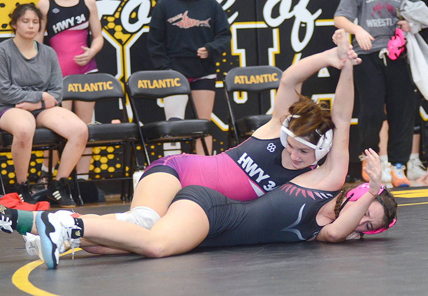 Grace Keeler of Highway 34 works to turn Raya Parker of S.W.A.T. during Thursday's dual meet in Atlantic. Keeler won by fall in 3:23 and placed second at 125 pounds on Friday at the Riverside Invitational.