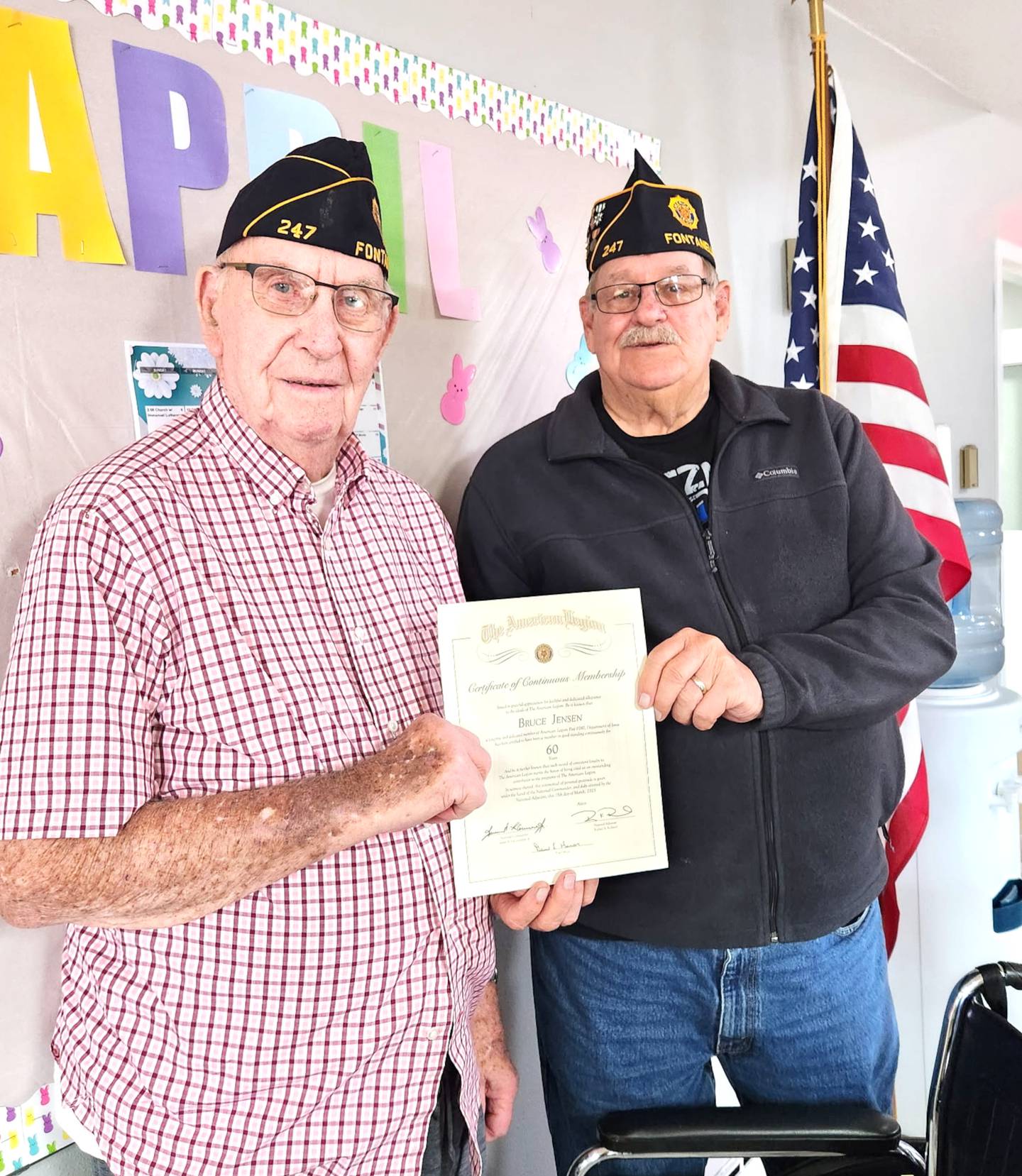 Bruce Jensen of Bridgewater (left) receives a certificate celebrating his 60 years as a member of Carlson American Legion Post 247 of Fontanelle from Post Treasurer Dave Homan.