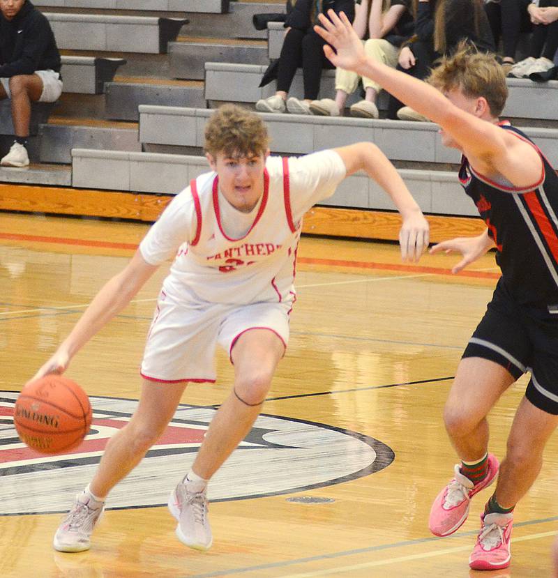 Creston's Baret Lane drives against Benjamin Glasgow of North Polk on Saturday.