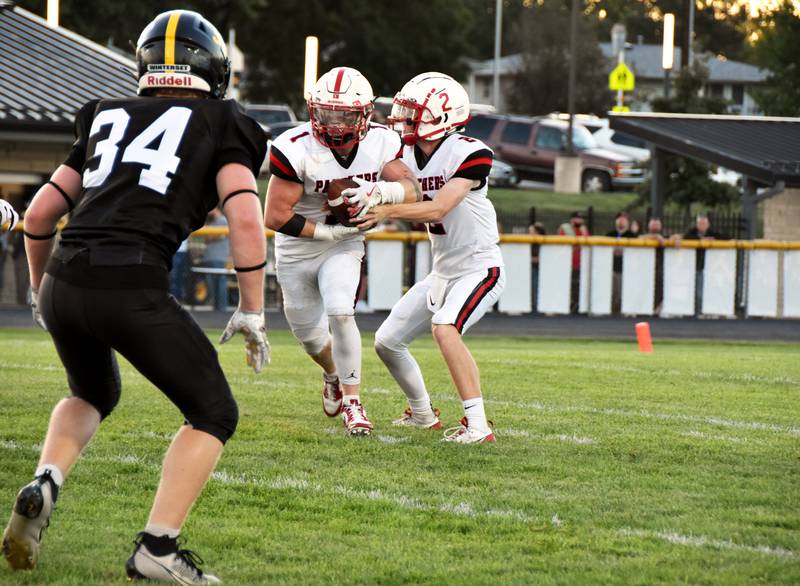 Creston quarterback Tanner Ray (No. 2) hands the ball to running back Weston Trapp (No. 1) during their season opener Friday at Winterset. This week, the Panthers host Class 4A reining state champions Lewis Central.
