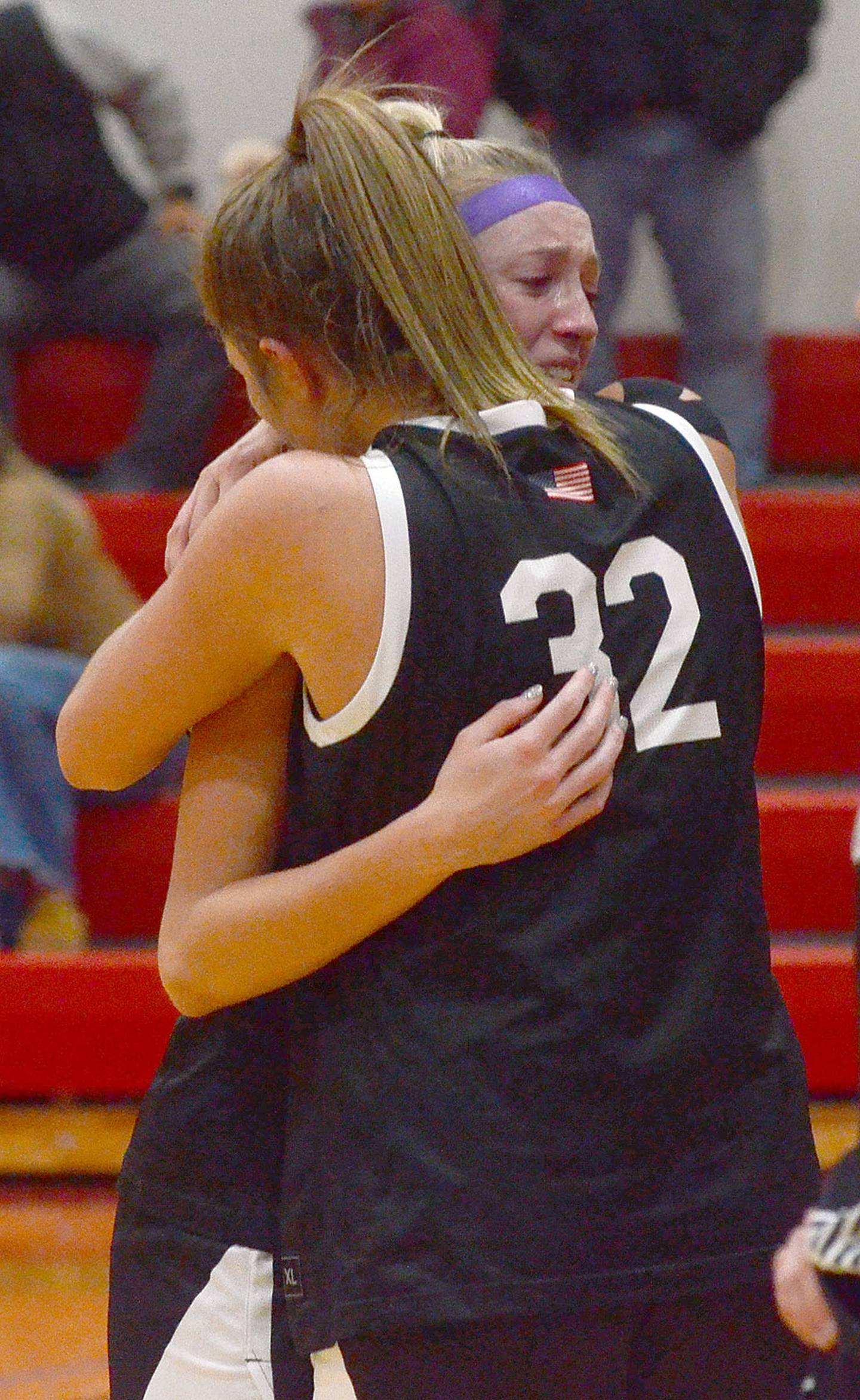 Nodaway Valley seniors Izzy Eisbach and Emma Boswell (32) embrace after Friday's regional loss at Earlham. Eisbach ended her career as Nodaway Valley's all-time leading scorer and ranks 10th all-time in Iowa with 2,270 points. Boswell is Iowa's all-time leading rebounder with 1,616 rebounds. She also scored 1,456 points playing for Orient-Macksburg and Nodaway Valley.