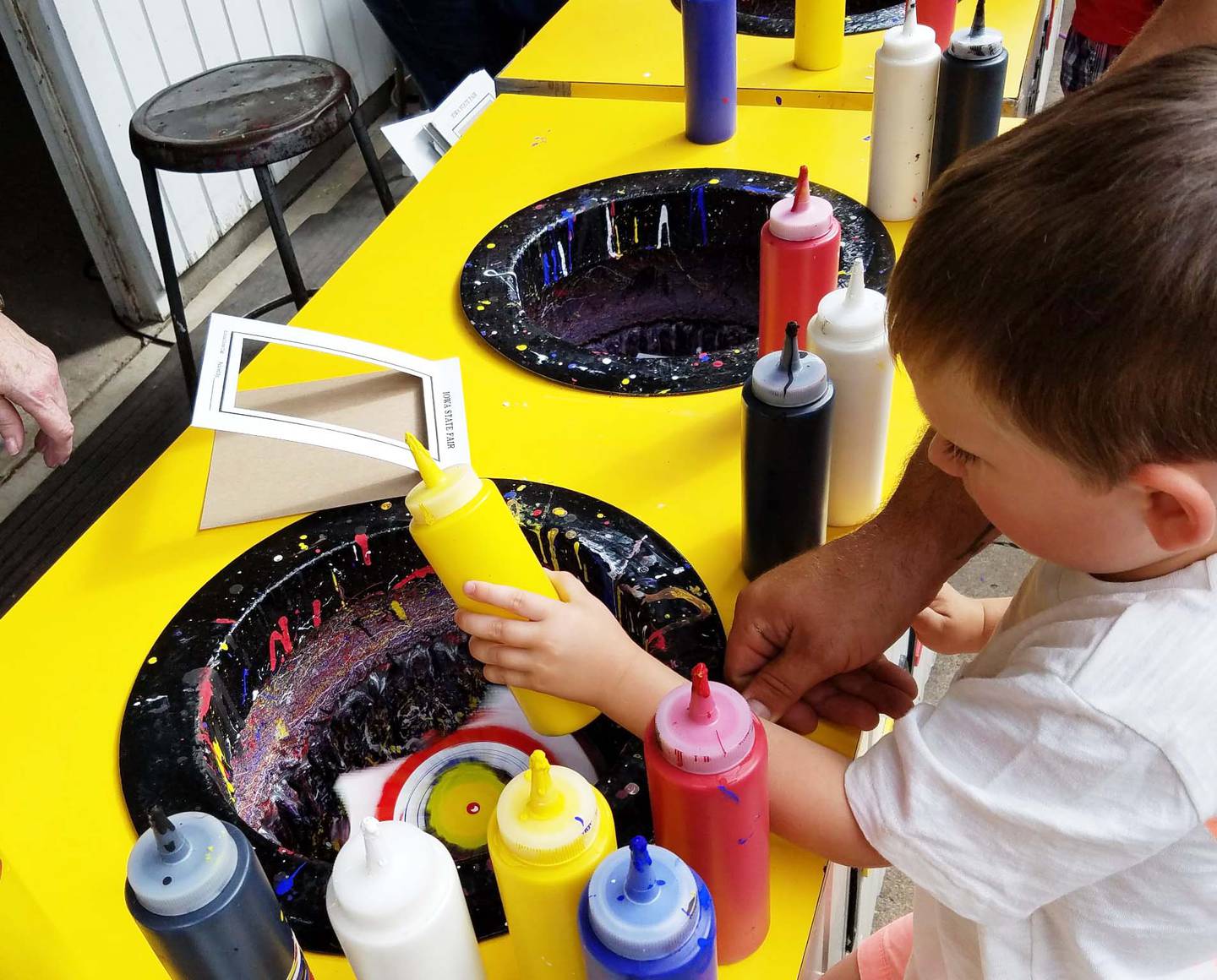 Tessa Stoffer's son Stryder creates spin art in 2016 at the Iowa State Fair. The activity was a tradition between Stouffer and her dad growing up.