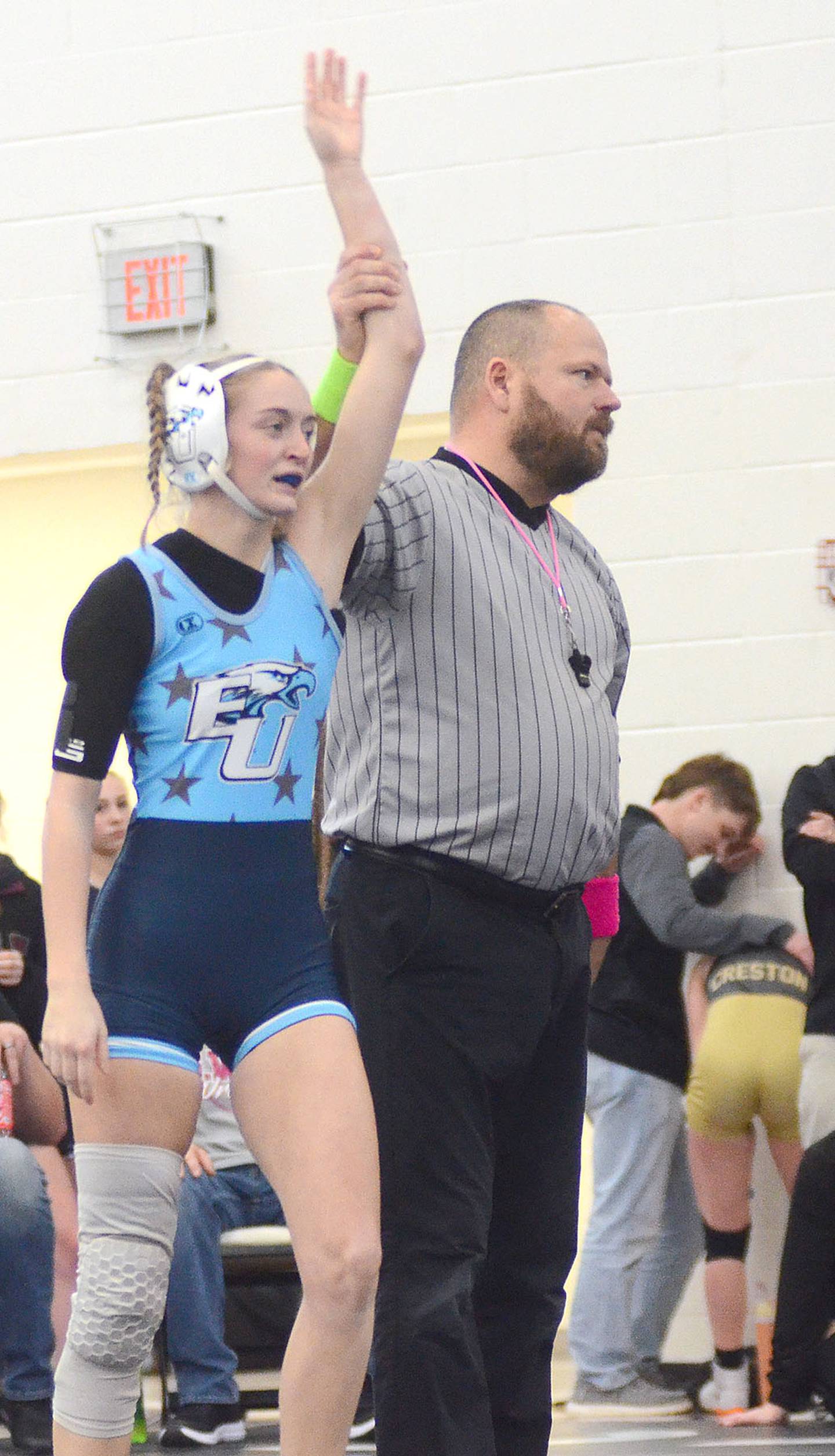 Quynn Foster of East Union has her hand raised as winner of the 105-pound championship match Saturday. Foster pinned SWAT's Addi Glade in 30 seconds.