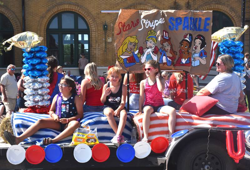 Union County Fair princess candidates wave during the annual Fourth of July parade.