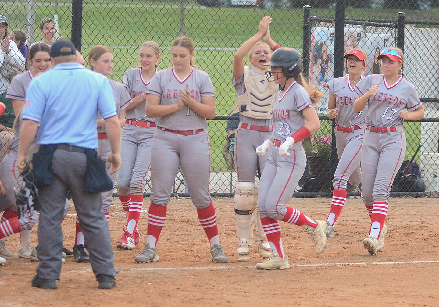 Teammates cheer for Creston's Avery Staver as she approaches home plate after hitting a home run in the third inning against Atlantic Wednesday. It was Staver's third home run of the season.