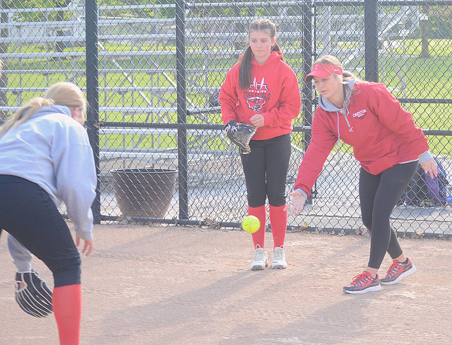 Creston coach Gracie Hagle leads a fielding technique drill during a recent practice.