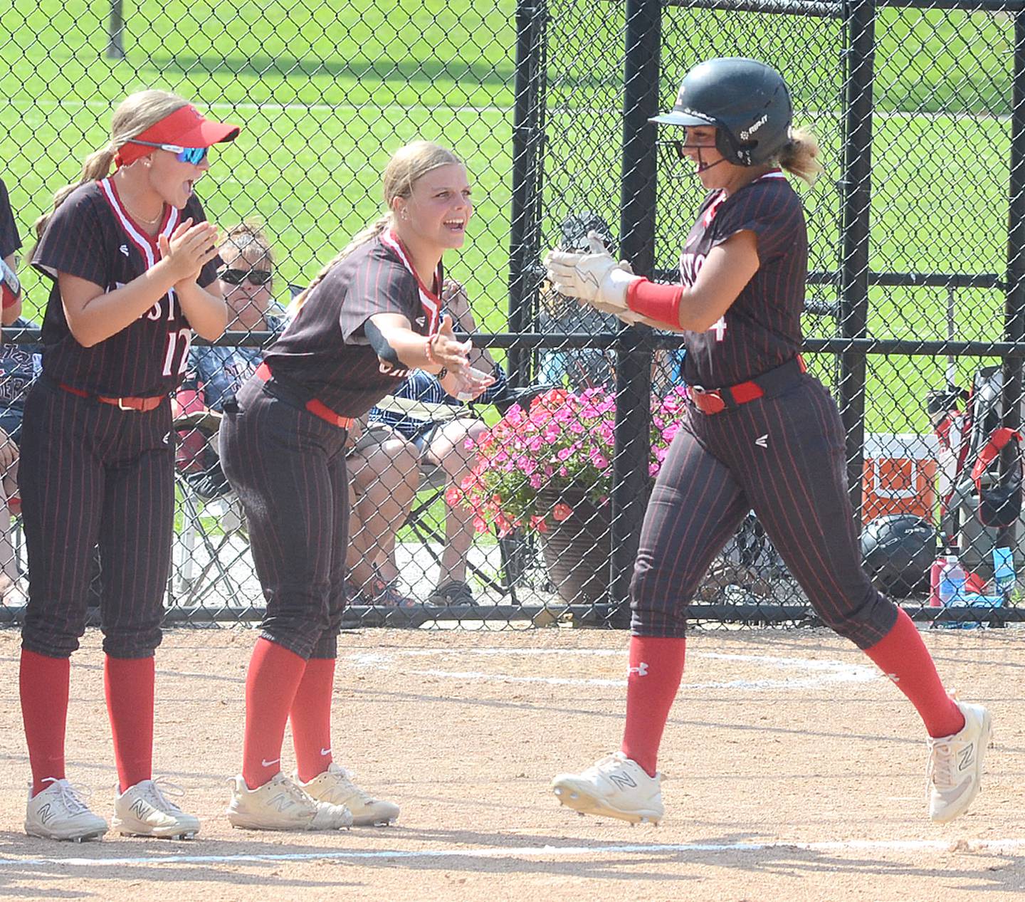 Teammates greet Creston's Jersey Foote after her two-run homer lifted the Panthers to a 6-5 lead over Denison-Schleswig on the way to a 10-5 victory Friday. Foote clubbed four home runs in three games over the weekend, pushing her season total to 10.