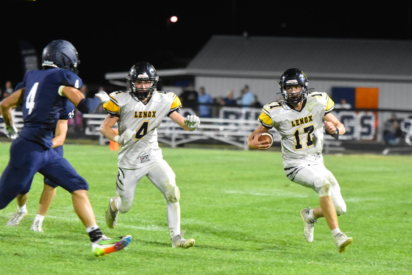 Dalton Kitzman (No. 4) readies to block for quarterback Gabe Funk (No. 17) who ran for four touchdowns and 203 yards against the Bulldogs.