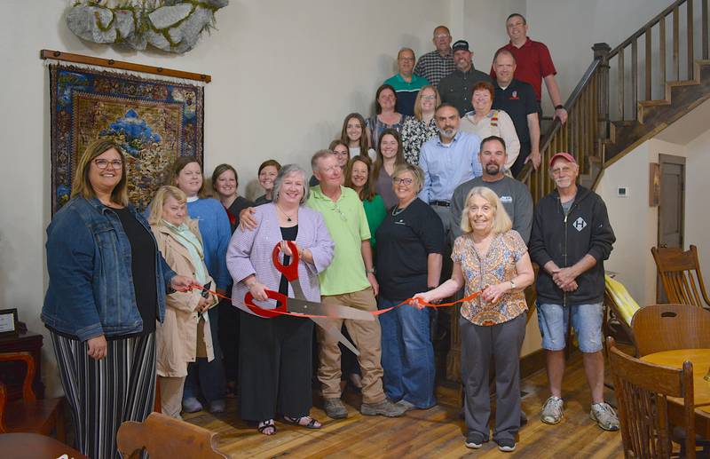 Members of the local community gather for the ribbon cutting ceremony at Liberty Hall. Loretta Harvey prepares to cut the ribbon with her husband Aaron Finch to her left.